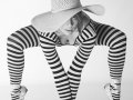 This fine art boudoir print includes a model who is nude, yet appears fully clothed due to artistic considerations and choice of camera angles