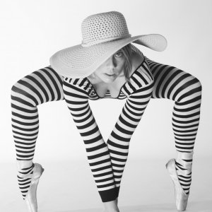 This fine art boudoir print includes a model who is nude, yet appears fully clothed due to artistic considerations and choice of camera angles